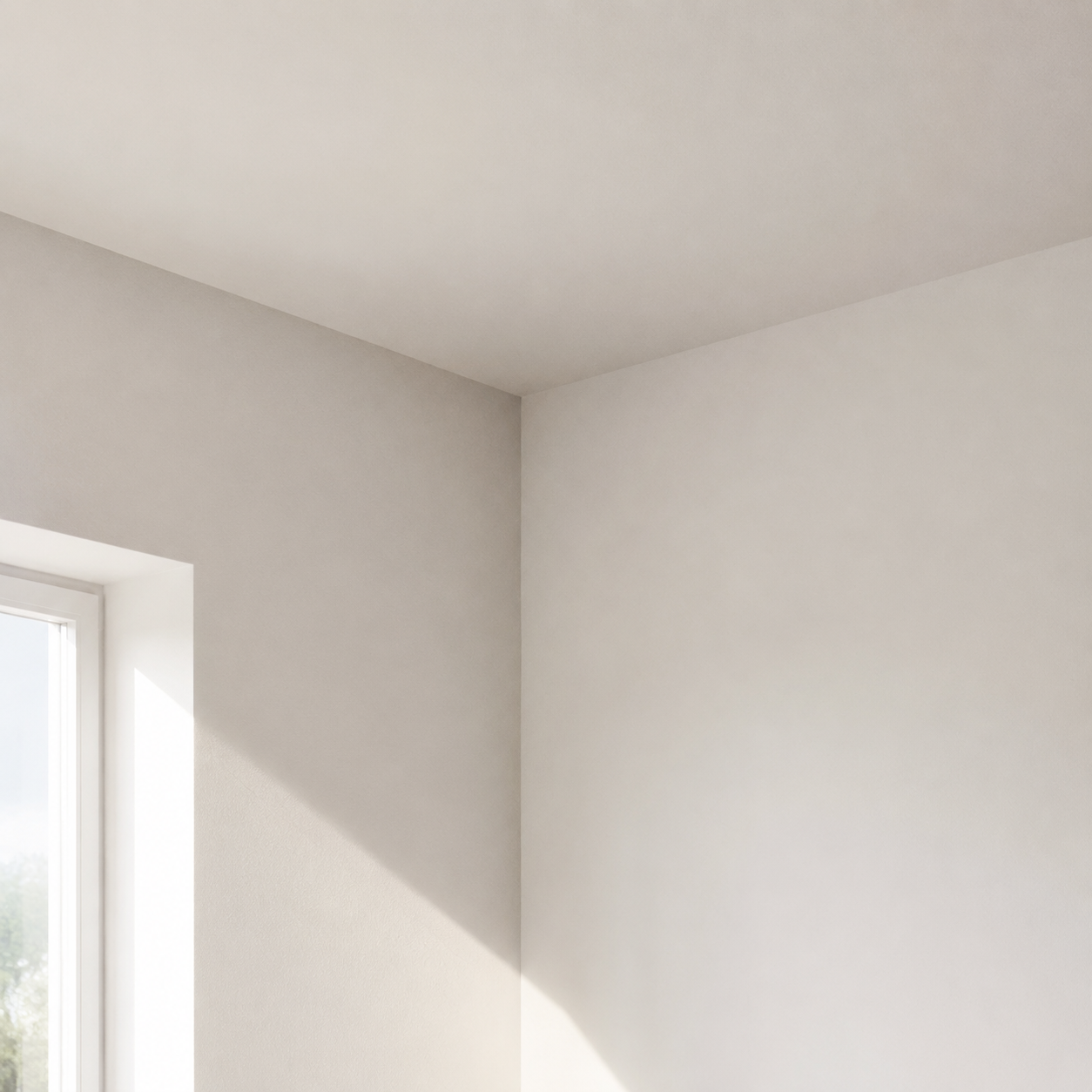 Strak gespoten witte wand en plafond in een lege gerenoveerde kamer